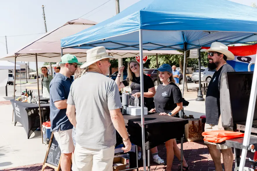 Guests gathered under tents at a Fire & Table event in downtown Gainesville