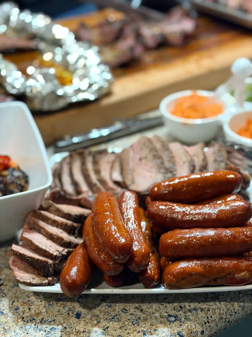 Smoked sausage and sliced beef on a serving platter